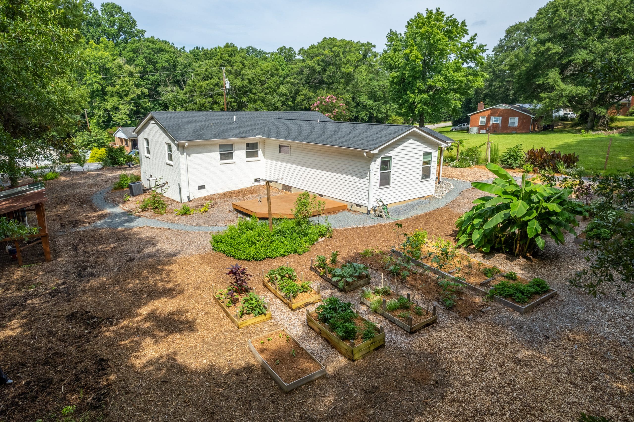 Cottage home in Indian Land with edible gardens, raised beds, chicken coop, yoga deck, and mature trees near Ballantyne.