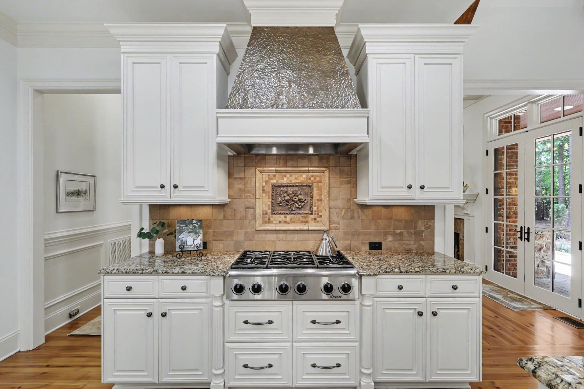 Custom kitchen cabinetry with copper vent hood and Dacor gas cooktop at 508 Hideaway Ridge Court