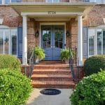 Brick home exterior with blue front door at 8724 Suninghurst Lane in Kensington at Ballantyne, Charlotte NC