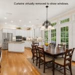Open kitchen and breakfast nook with wall of windows in Ballantyne Charlotte NC home
